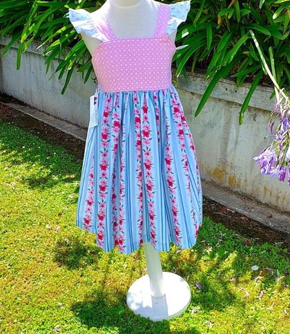 Another pretty flutter sleeve summer dress. Baby blues and pinks fabrics. Size 2, 5 & 7 available.