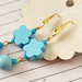 Baby blue long dangling wooden flowers, round balls and glass beads gold plated earrings 