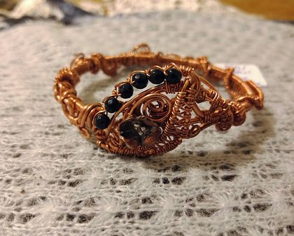 Elaborate wire wrapped copper bangle with sandstone beads