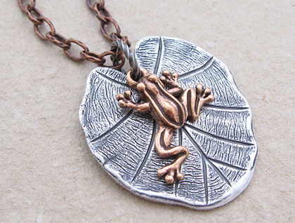 Lily Pad necklace: a small copper frog charm on a silver lily-pad pendant