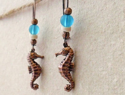 Burnished Ocean earrings: antiqued-copper seahorses with coconut shell and blue glass