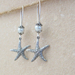 Starfish Treasure earrings in silver: lifelike starfish charms with white faux pearls