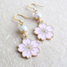 Sakura earrings: pale pink blossom charms on gold ear-hooks 